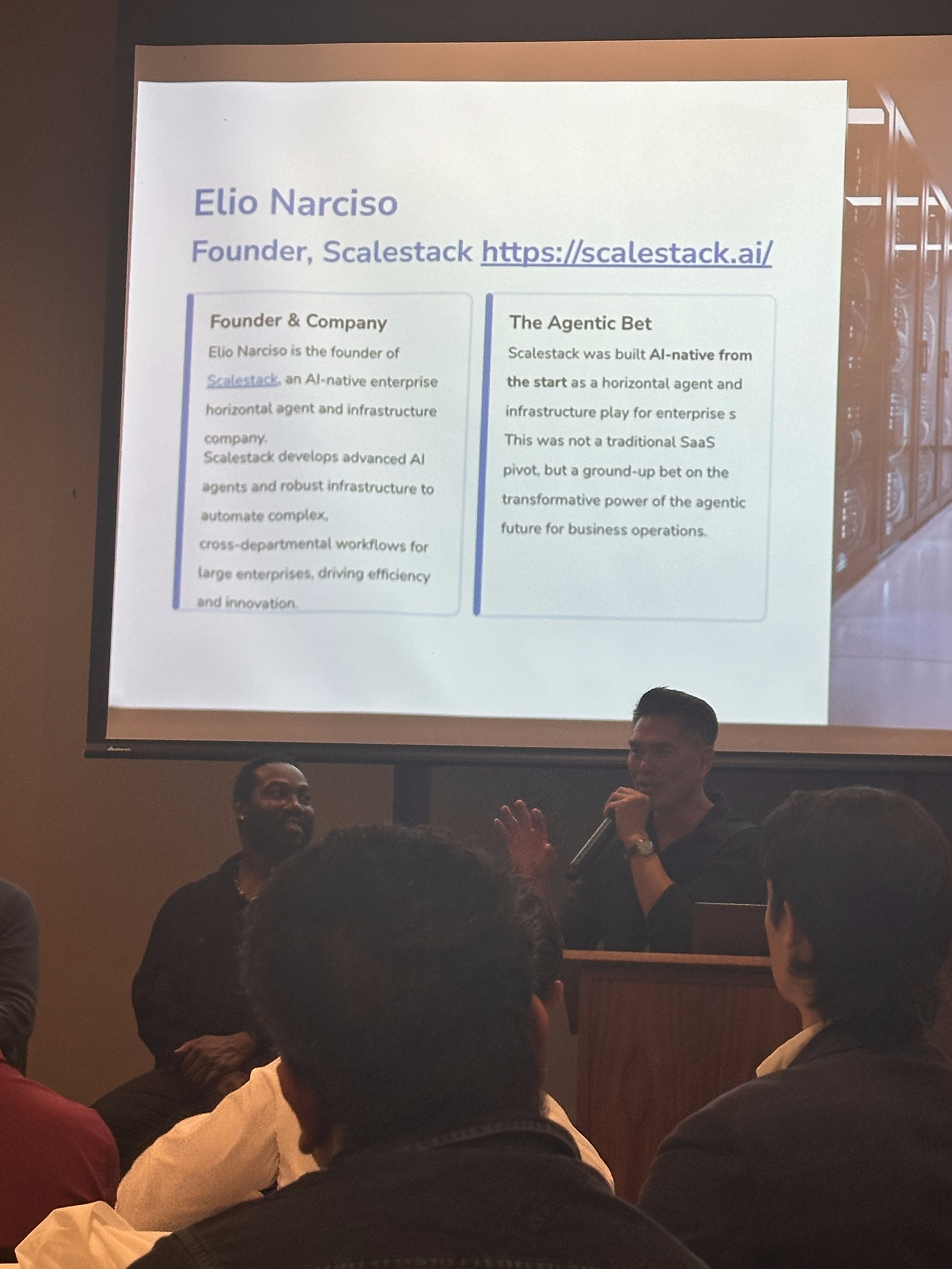 Evan Chen, founder of Akia, presenting on the panel with his hospitality AI agent transition slide visible.